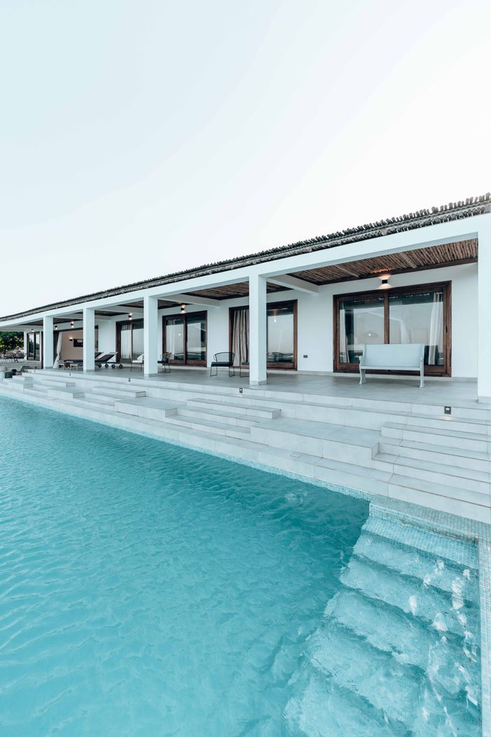 A sleek and luxurious villa with a modern swimming pool and inviting patio.