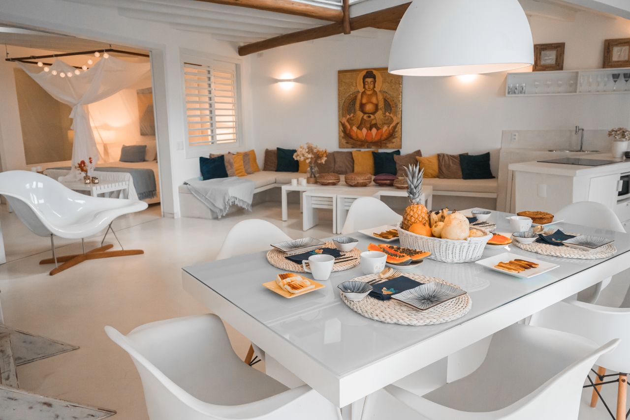 Modern dining room setup with sleek furniture and artful table setting for a luxurious meal.