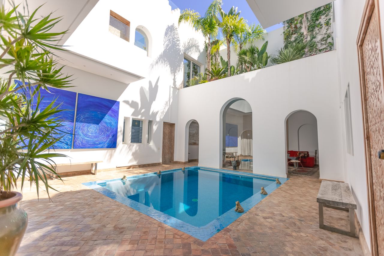 Elegant villa in Rabat with arched architecture and a luxurious pool.