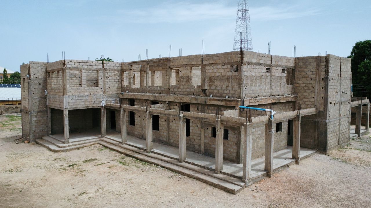An unfinished concrete building in outdoor setting with clear sky